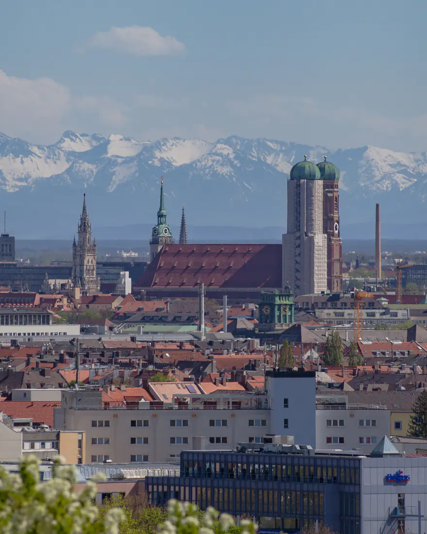 Munich's rooftops and the Frauenkirche towers with the Alps behind