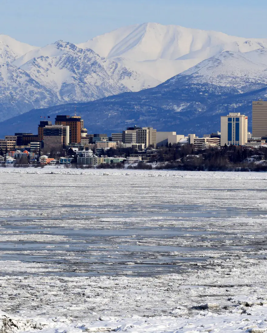 Anchorage's skyline in front of the snow-covered Chugach Mountains