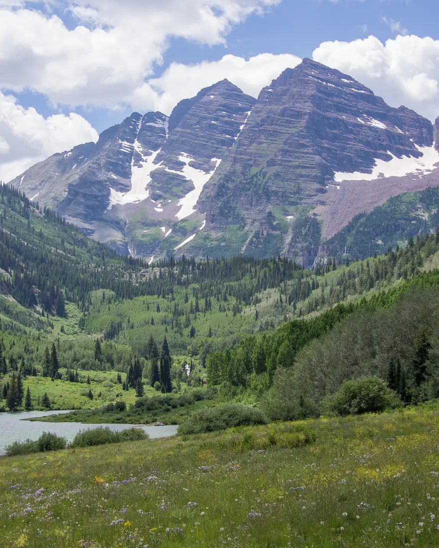 The Maroon Bells above a summer valley near Aspen