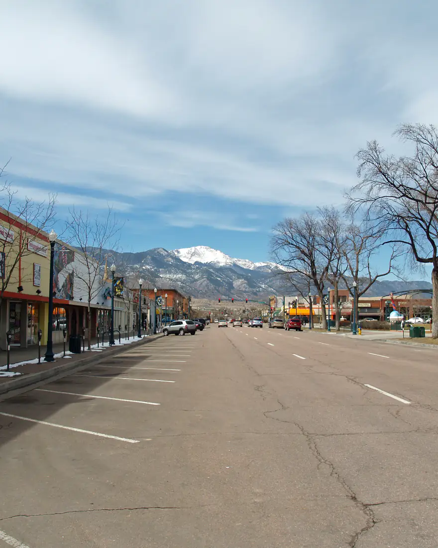 A downtown Colorado Springs street with Pikes Peak in the distance