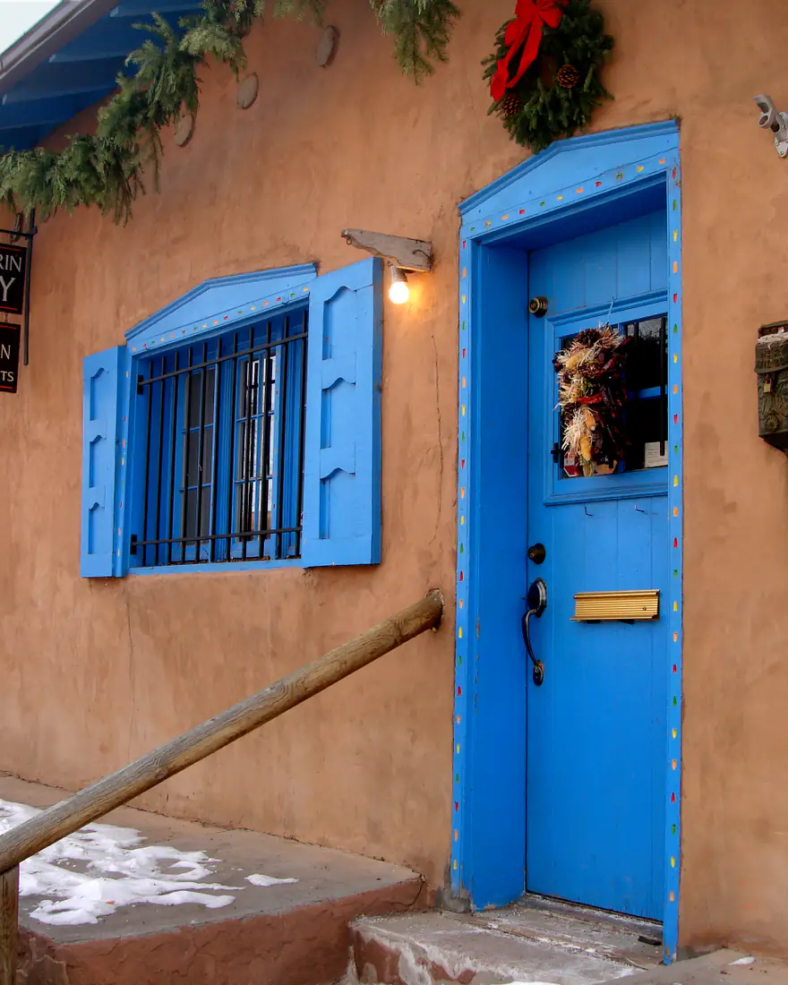 An adobe gallery with blue doors on Canyon Road, Santa Fe