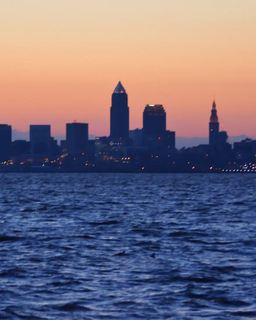 Cleveland's skyline silhouetted over Lake Erie at sunrise